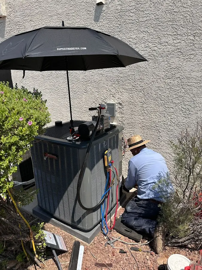 HVAC technician performing outdoor AC maintenance in Carroll